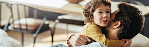 Man hugging toddler