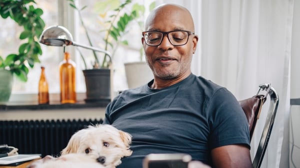 Man sitting at desk with dog