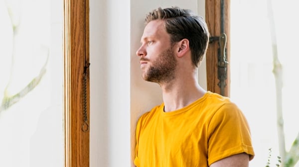 Man staring out of window