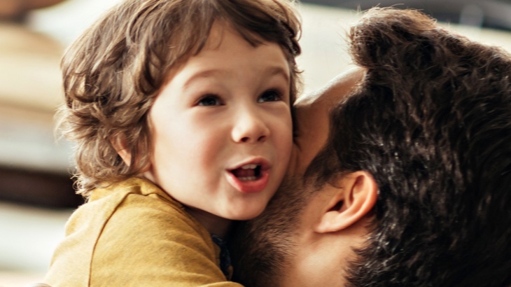 Man hugging boy