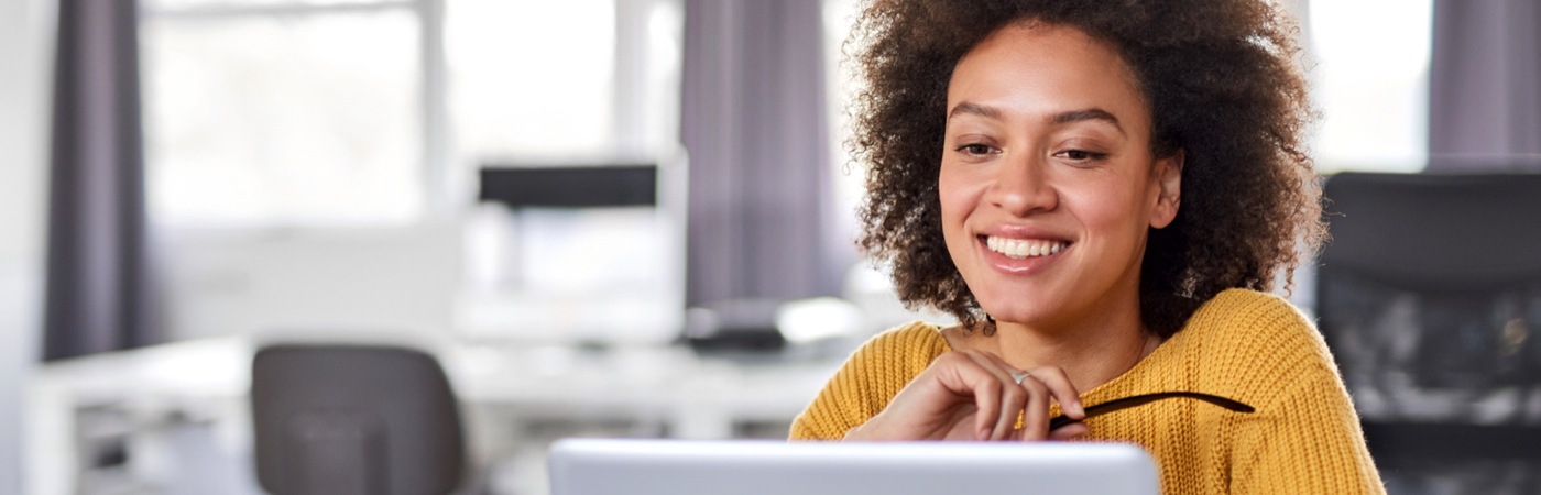 Woman smiling at laptop