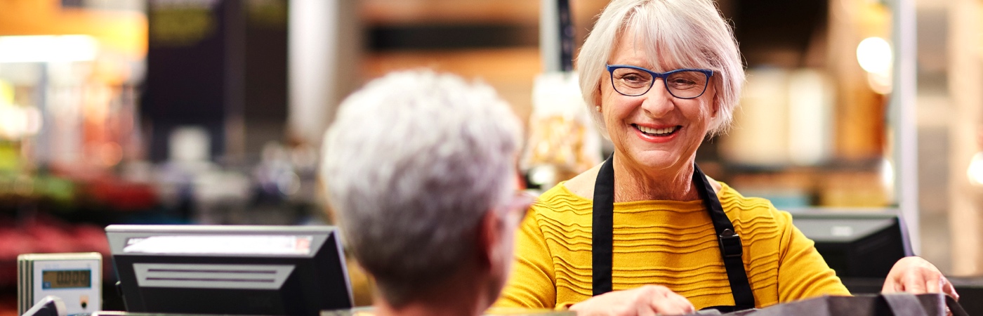 Woman packing bags at supermarket