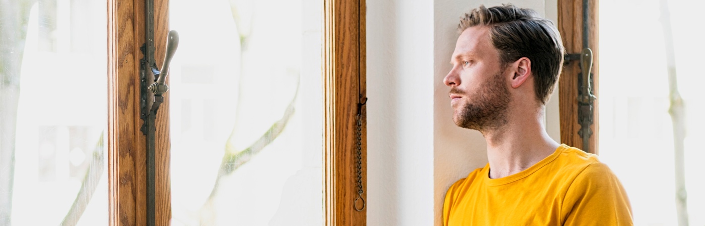 Man looking out of window